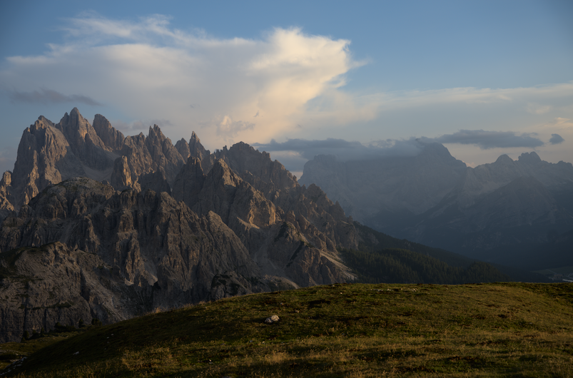 Mountain peaks beneath a cloudy sky