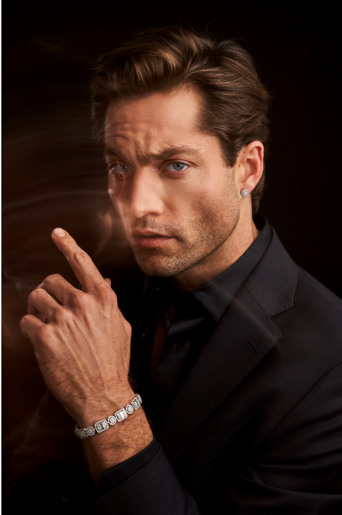 Portrait of a man in a black suit against a dark background