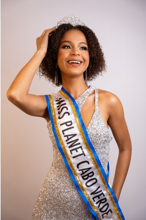 Smiling woman wearing a crown and silver dress